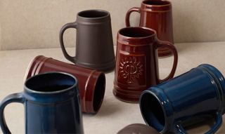 Set of ceramic mugs in various colors.