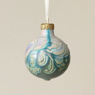 Intricately carved and glazed ceramic globe ornament with ivory satin ribbon –