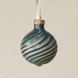 Intricately carved and glazed ceramic globe ornament with ivory satin ribbon –