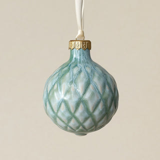 Intricately carved and glazed ceramic globe ornament with ivory satin ribbon –