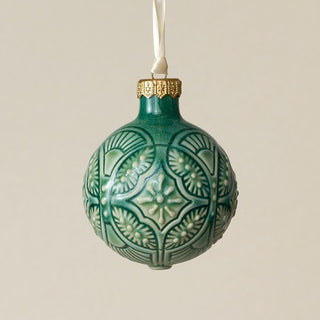 Intricately carved and glazed ceramic globe ornament with ivory satin ribbon –