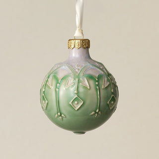 Intricately carved and glazed ceramic globe ornament with ivory satin ribbon –