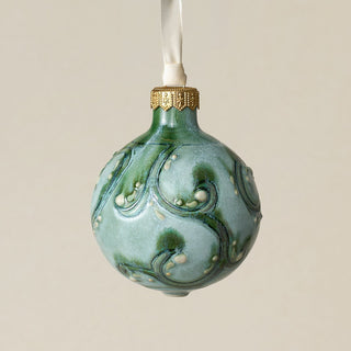 Intricately carved and glazed ceramic globe ornament with ivory satin ribbon –