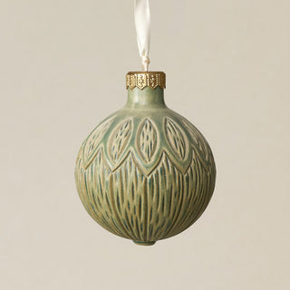 Intricately carved and glazed ceramic globe ornament with ivory satin ribbon –