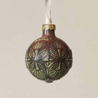 Intricately carved and glazed ceramic globe ornament with ivory satin ribbon –