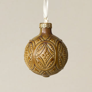 Intricately carved and glazed ceramic globe ornament with ivory satin ribbon –