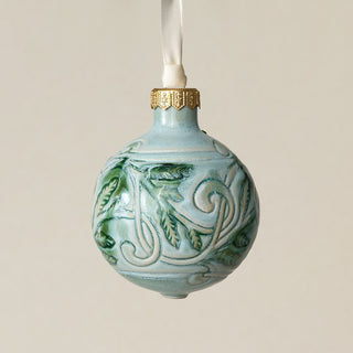 Intricately carved and glazed ceramic globe ornament with ivory satin ribbon –