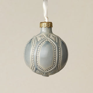Intricately carved and glazed ceramic globe ornament with ivory satin ribbon –