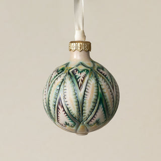 Intricately carved and glazed ceramic globe ornament with ivory satin ribbon –