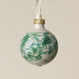 Intricately carved and glazed ceramic globe ornament with ivory satin ribbon –