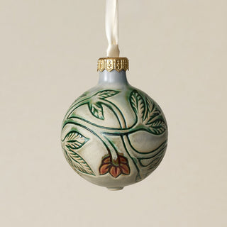 Intricately carved and glazed ceramic globe ornament with ivory satin ribbon –