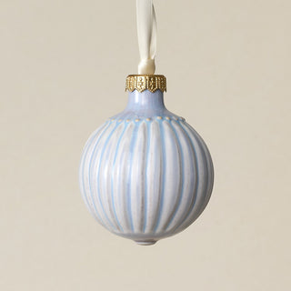 Intricately carved and glazed ceramic globe ornament with ivory satin ribbon –