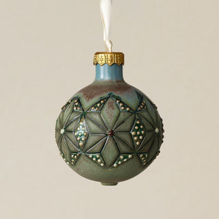 Intricately carved and glazed ceramic globe ornament with ivory satin ribbon –