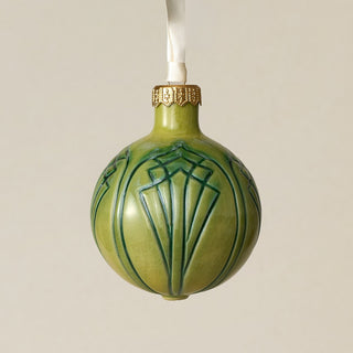 Intricately carved and glazed ceramic globe ornament with ivory satin ribbon –