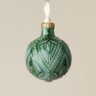 Intricately carved and glazed ceramic globe ornament with ivory satin ribbon –