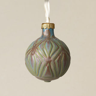 Intricately carved and glazed ceramic globe ornament with ivory satin ribbon –