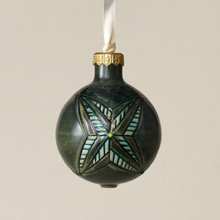 Intricately carved and glazed ceramic globe ornament with ivory satin ribbon –