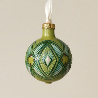 Intricately carved and glazed ceramic globe ornament with ivory satin ribbon –