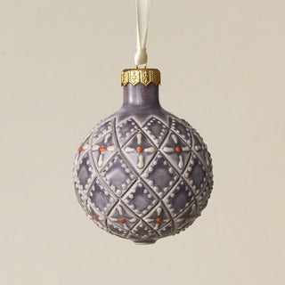 Intricately carved and glazed ceramic globe ornament with ivory satin ribbon –