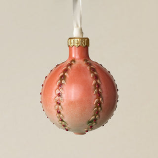 Intricately carved and glazed ceramic globe ornament with ivory satin ribbon –