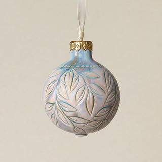Intricately carved and glazed ceramic globe ornament with ivory satin ribbon –