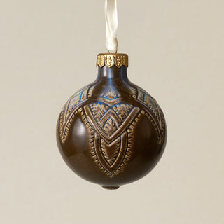 Intricately carved and glazed ceramic globe ornament with ivory satin ribbon –
