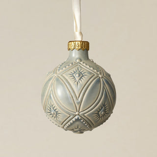 Intricately carved and glazed ceramic globe ornament with ivory satin ribbon –