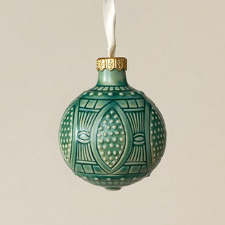 Intricately carved and glazed ceramic globe ornament with ivory satin ribbon –