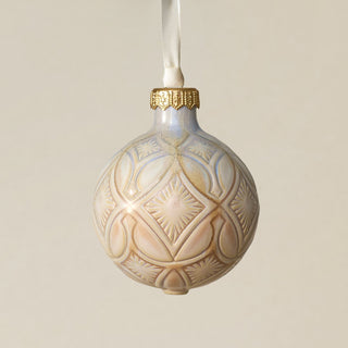 Intricately carved and glazed ceramic globe ornament with ivory satin ribbon –