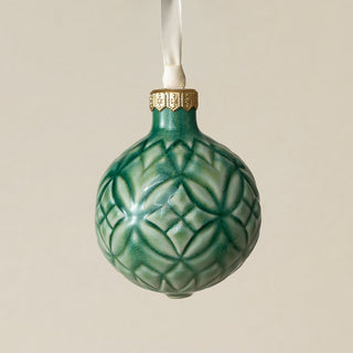 Intricately carved and glazed ceramic globe ornament with ivory satin ribbon –