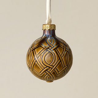 Intricately carved and glazed ceramic globe ornament with ivory satin ribbon –