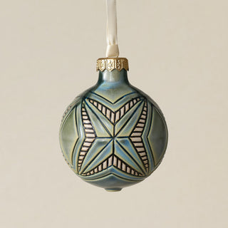Intricately carved and glazed ceramic globe ornament with ivory satin ribbon –