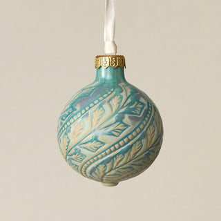 Intricately carved and glazed ceramic globe ornament with ivory satin ribbon –