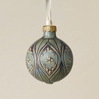 Intricately carved and glazed ceramic globe ornament with ivory satin ribbon –