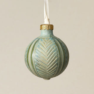 Intricately carved and glazed ceramic globe ornament with ivory satin ribbon –