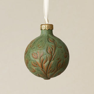 Intricately carved and glazed ceramic globe ornament with ivory satin ribbon –