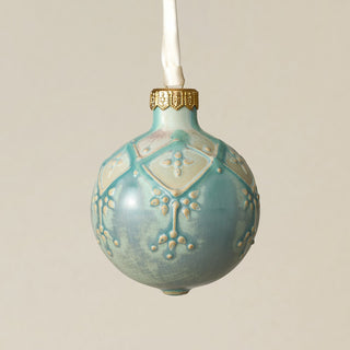 Intricately carved and glazed ceramic globe ornament with ivory satin ribbon –