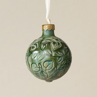 Intricately carved and glazed ceramic globe ornament with ivory satin ribbon –