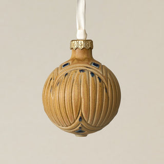 Intricately carved and glazed ceramic globe ornament with ivory satin ribbon –