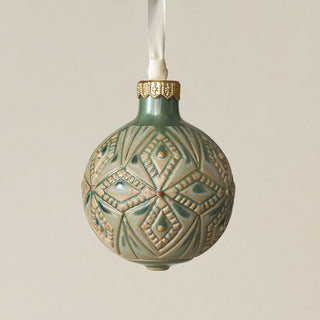 Intricately carved and glazed ceramic globe ornament with ivory satin ribbon –