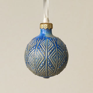 Intricately carved and glazed ceramic globe ornament with ivory satin ribbon –