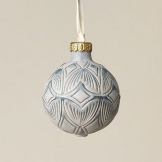 Intricately carved and glazed ceramic globe ornament with ivory satin ribbon –