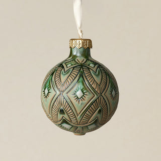 Intricately carved and glazed ceramic globe ornament with ivory satin ribbon –
