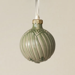 Intricately carved and glazed ceramic globe ornament with ivory satin ribbon –