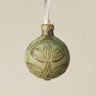 Intricately carved and glazed ceramic globe ornament with ivory satin ribbon –