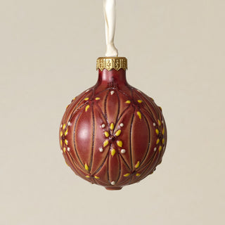 Intricately carved and glazed ceramic globe ornament with ivory satin ribbon –