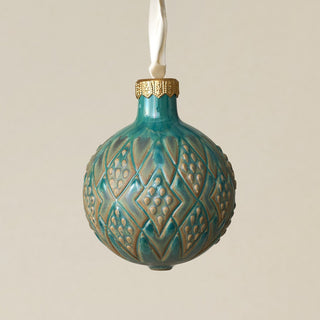 Intricately carved and glazed ceramic globe ornament with ivory satin ribbon –