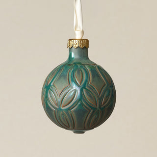 Intricately carved and glazed ceramic globe ornament with ivory satin ribbon –