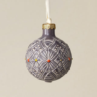 Intricately carved and glazed ceramic globe ornament with ivory satin ribbon –