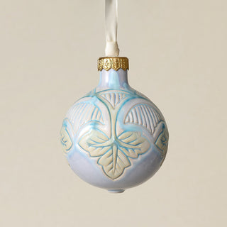 Intricately carved and glazed ceramic globe ornament with ivory satin ribbon –
